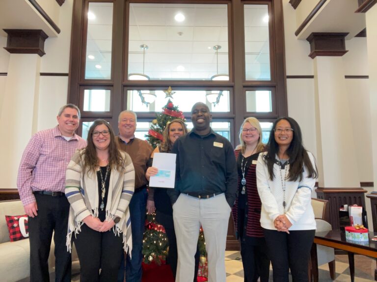 Photo of people smiling at the Holidays of Giving event in Brookfield