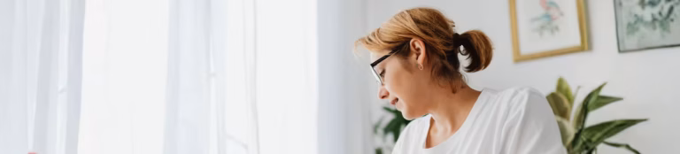 Woman organizing personal finances and counting cash for a money market savings goal.